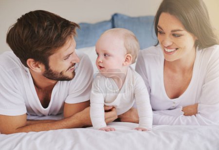 Photo for Their pride and joy. a young couple and their baby daughter in the bedroom - Royalty Free Image
