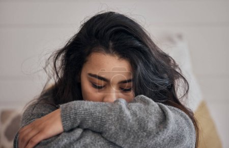Woman, stress and depression in lonely mental health problems, issues or anxiety at home. Sad female face suffering from loneliness, withdrawal or abuse with depressed emotion alone in the bedroom.