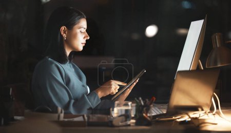 Laptop, computer or business woman on tablet at night in office for research, cloud computing or planning marketing schedule. IT, programmer or developer working overtime review startup cybersecurity.
