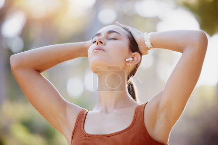 Fitness, woman and runner breathing in relax for healthy cardio exercise, workout or training in the outdoors. Active female feel good in the fresh air for health and wellness before running outside.