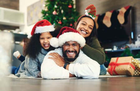 Christmas, portrait and happy family, living room floor and ground, winter celebration and love, care and happiness together. Parents, girl and excited child celebrate festive holidays in home lounge.