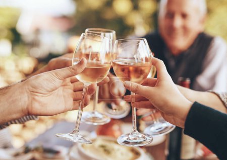 Hands, glass and cheers with a group of people drinking alcohol together outdoor in celebration of the festive season. Party, wine and drink with a man and woman family doing cheers to tradition.