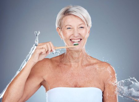 Photo for Toothbrush, portrait and senior woman dental healthcare studio mockup brushing teeth for dentist and whitening advertising. Smile of elderly model mouth with breath fresh toothpaste and water splash. - Royalty Free Image