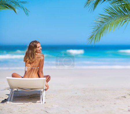 Photo for Tropical, relax and woman at the beach for holiday, travel and summer by the ocean in Bali. Nature, happy and girl on a chair by the sea for an island vacation in a bikini with a smile by the water. - Royalty Free Image