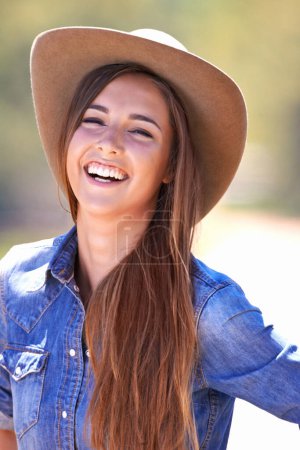 Photo for Heading off to the rodeo. A beautiful cowgirl standing outdoors - Royalty Free Image