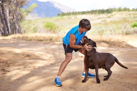 Photo for Dogs need their exercise too. a young man exercising outdoors with his dog - Royalty Free Image