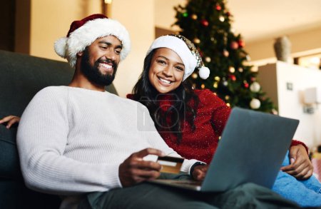 Photo for Credit card, Christmas and black couple on laptop and sofa for home online shopping, easy e commerce payment and banking. Happy people on couch in living room with website sale on holiday finance app. - Royalty Free Image
