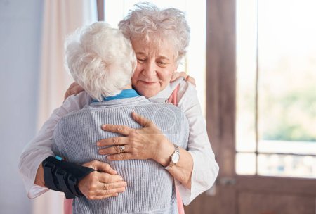 Photo for Elderly women, hug and nursing home, friends and support, comfort and care, together with bond. Senior people hugging, retirement and love with friendship in retirement home and connection - Royalty Free Image