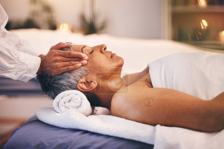 Hands, old woman and head massage at spa for wellness, relax and stress relief. Luxury, zen and peace with elderly female on table with masseuse for physical therapy, skincare or facial treatment