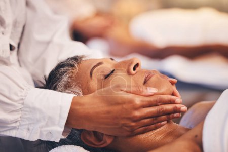 Face massage, woman and relax at spa for wellness, luxury cosmetology and zen cosmetics. Facial aesthetics, beauty salon and physical therapy for healthy skincare of mature lady with body dermatology.