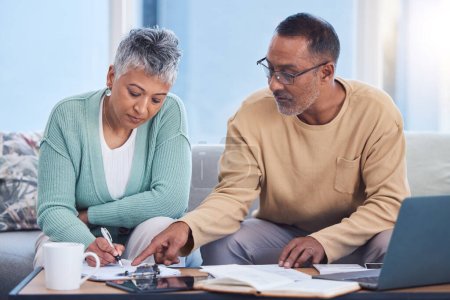 Photo for Senior black couple, taxes and home with laptop, documents or focus in home for family finance. Elderly, woman and man with computer, tablet or notebook in audit, budget or planning on lounge sofa. - Royalty Free Image