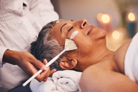 Photo for Facial, relax and senior woman at a spa for a wellness, health and skin treatment at a resort. Peace, calm and elderly lady doing a luxury anti aging face mask with a therapist at a zen beauty salon - Royalty Free Image