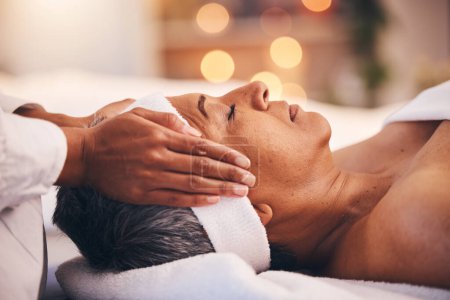 Wellness, health and massage, senior woman at a spa getting luxury beauty therapy and facial. Mature black woman, zen and masseuse massaging oil on head to help relax body and mind for stress relief