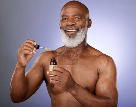 Photo for Beauty, portrait and senior man with serum for skincare, health and wellness on a grey studio background. Face, oil and skin care with cosmetic glowing skin of an african american male with product. - Royalty Free Image