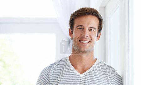 Photo for Happy to be home. A young man in casual clothes smiling at the camera - Royalty Free Image