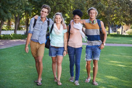Photo for We love college. Portrait of group of students taking a walking in a park after class - Royalty Free Image
