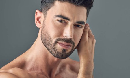 Photo for Man, face and skincare on gray studio background in healthcare wellness, Brazilian beard or collagen dermatology. Portrait, model headshot and facial hair growth on grey backdrop or grooming routine. - Royalty Free Image