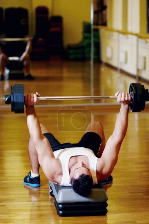 Photo for Playtime at the gym. Handsome sportive man at the gym doing exercises - Royalty Free Image