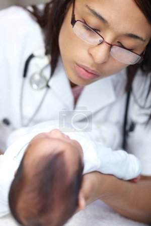 Photo for Going for her annual checkup. A young female doctor examining an infant who has a cleft palate - Royalty Free Image