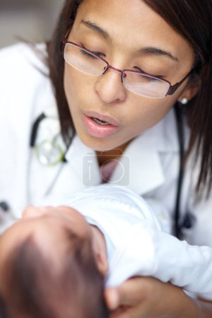 Photo for Getting a thorough checkup. A young female doctor examining an infant who has a cleft palate - Royalty Free Image