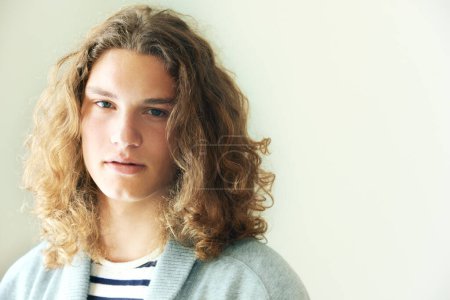 Photo for Hes got a unique look. Casual young man with long, curly hair - Royalty Free Image