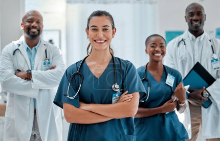 Group of happy diverse doctors standing with their arms crossed while working at a hospital. Expert medical professionals smiling at work together at a clinic.