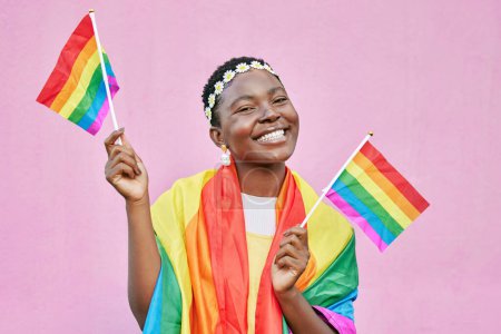 Black woman, flag and pride with lgbtq portrait, freedom and support queer community with happiness against pink background. Rainbow, sexuality and free to love mockup, celebrate lgbt and equality