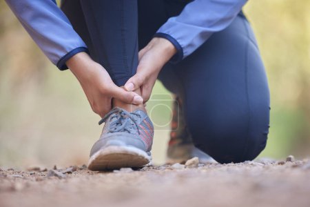 Photo for Running, ankle pain and injury with shoes of black woman on nature trail for training, jogging and endurance. Sprain, accident and broken with girl runner on path for workout, exercise and sports. - Royalty Free Image