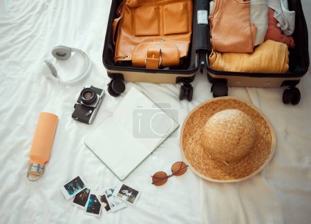 Backpacking, suitcase and equipment for summer travel, vacation or holiday getaway kit preparation on bed. Tourism, packing and items for traveler, trip or tourist adventure, explorer gear in bedroom.