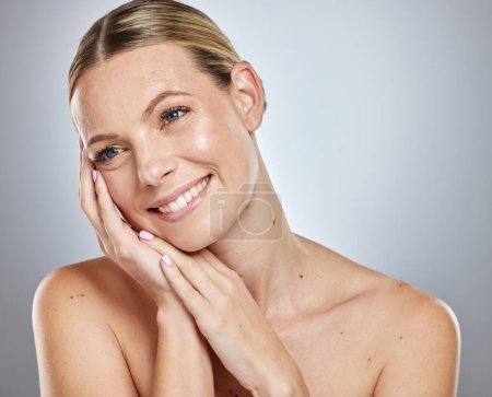 Photo for Face, beauty makeup and skincare of woman in studio isolated on a gray background. Aesthetics, natural cosmetics or happy female model thinking about spa facial treatment for wellness or healthy skin. - Royalty Free Image