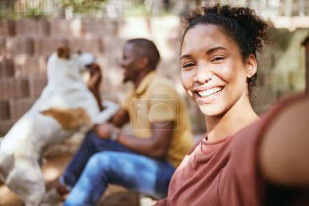 Photo for Black woman, selfie and dog adoption with happiness and love with family outdoor. Puppy, pet and woman portrait in the sunshine happy about bringing animal to its new home in summer with a smile. - Royalty Free Image