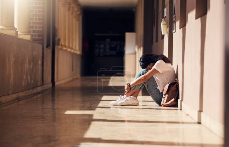 Photo for Sad, lonely and girl with depression at school, crying and anxiety after bullying. Mental health, tired and unhappy student in the corridor after problem in class, education fail and social isolation. - Royalty Free Image