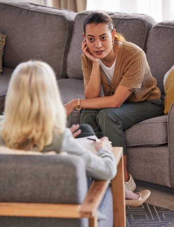 Counseling woman or psychologist listening to patient in therapy of mental health problem, mind healthcare or advisory support. Advice, psychology and professional therapist consulting client on sofa.