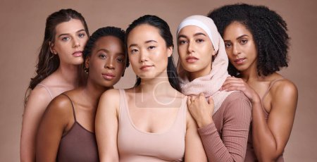 Photo for Portrait, beauty and diversity with a model woman group in studio on a brown background for inclusion. Face, natural and different with a female and friends posing to promote health or equality. - Royalty Free Image