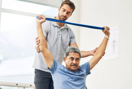 Photo for Raising his own standards. a young male physiotherapist assisting a senior patient in recovery - Royalty Free Image