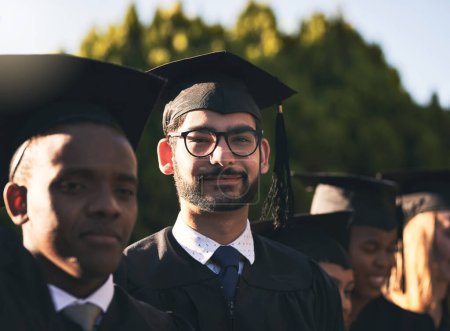 Photo for I really worked hard for this. Portrait of a smiling university student on graduation day with classmates in the background - Royalty Free Image