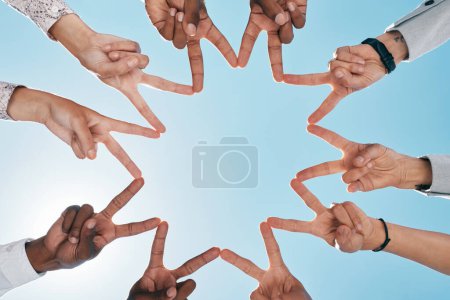 Téléchargez les photos : Team building, ciel bleu ou mains avec signe de paix pour le soutien, le travail d'équipe ou la collaboration en partenariat. Angle bas, confiance ou doigts témoignant de l'espoir, de la foi ou de la solidarité communautaire avec les objectifs de la mission. - en image libre de droit