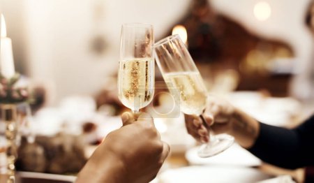 Photo for Its Christmas, bring out the bubbly. people making a toast over Christmas lunch - Royalty Free Image