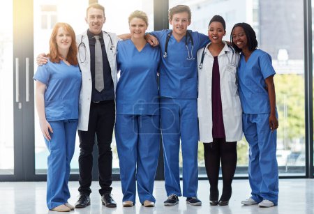Photo for Theyre some of the finest medical professionals around. Portrait of a group of medical practitioners standing together in a hospital - Royalty Free Image