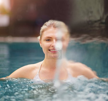 Photo for Letting off some steam in luxury. a young woman relaxing in the jacuzzi at a spa - Royalty Free Image