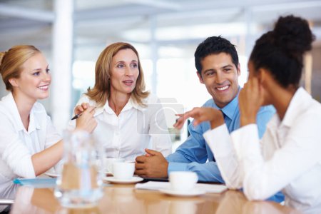 Photo for Business team discussing in board room. Portrait of multi racial business team discussing at board room - Royalty Free Image