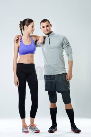 Photo pour Workout buddy. a young couple standing in a studio wearing sports clothing - image libre de droit