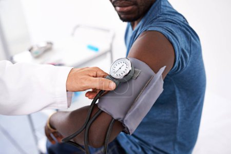 Photo for Part of every routine checkup. a doctor measuring a patients blood pressure - Royalty Free Image