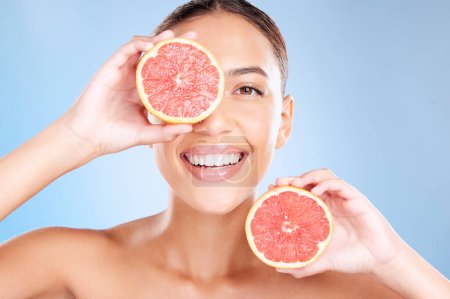 Photo for Beauty, grapefruit and woman with face and natural cosmetic care, facial and glow with vegan product against studio background. Skincare, healthy skin and wellness with fruit, hands and cosmetics - Royalty Free Image