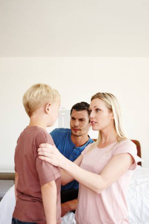 Photo for Working together as a team to discipline their son. A mother and father disciplining their son - Royalty Free Image