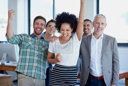 Photo for Cheers to teamwork. a group of happy coworkers celebrating standing in an office - Royalty Free Image