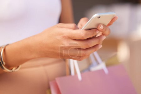 Photo pour Hands with smartphone, woman and shopping bag at mall for retail therapy with technology and communication. Mobile app, phone zoom and shopping, fashion and designer clothes at outdoor shopping mall - image libre de droit