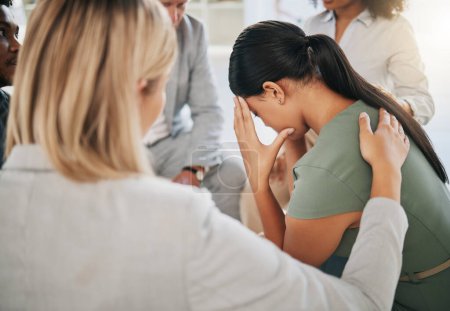 Téléchargez les photos : Grief, loss and woman at community support group for mental health, counseling or help. Solidarity, trust and group of people in circle comforting, helping and supporting lady with bad news together - en image libre de droit