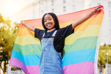 Photo for Black gay woman, rainbow flag and lgbtq pride with a smile for sexuality freedom, non binary and gender neutral lifestyle. Portrait of young lesbian girl in city of France for equality and love. - Royalty Free Image