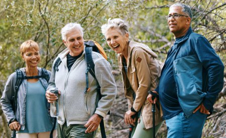 Photo for Nature, hiking and happy senior friends bonding, talking and laughing at comic joke in forest. Happiness, fun and group of elderly people trekking together for health, wellness and exercise in woods - Royalty Free Image